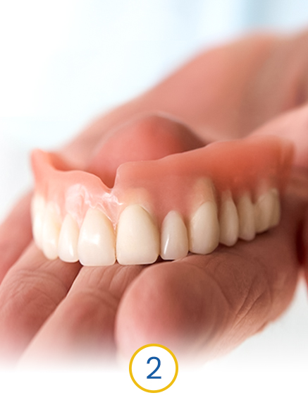 dentist holding a temporary dental prosthesis for immediate load dental implants