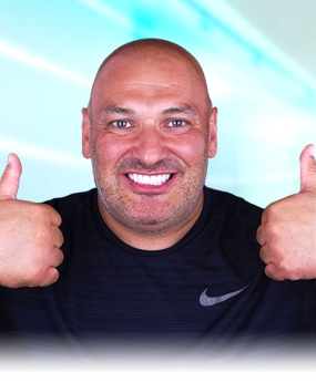 bald man smiling after getting affordable dental care in Mexico
