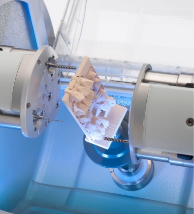 cad-cam milling machine fabricating a set of zirconia crowns