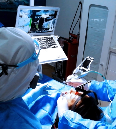 Cancun Dental Specialists performing a dental implant surgery on a female patient