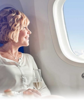 elder woman traveling on a plane to get a full mouth rehabilitation in Mexico